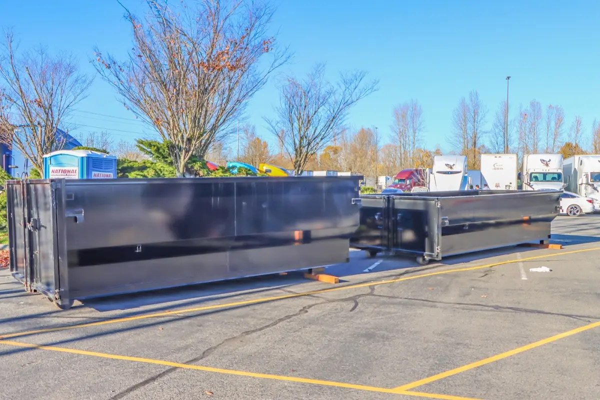 Professional dumpster rental service with roll-off container on residential driveway in El Sobrante